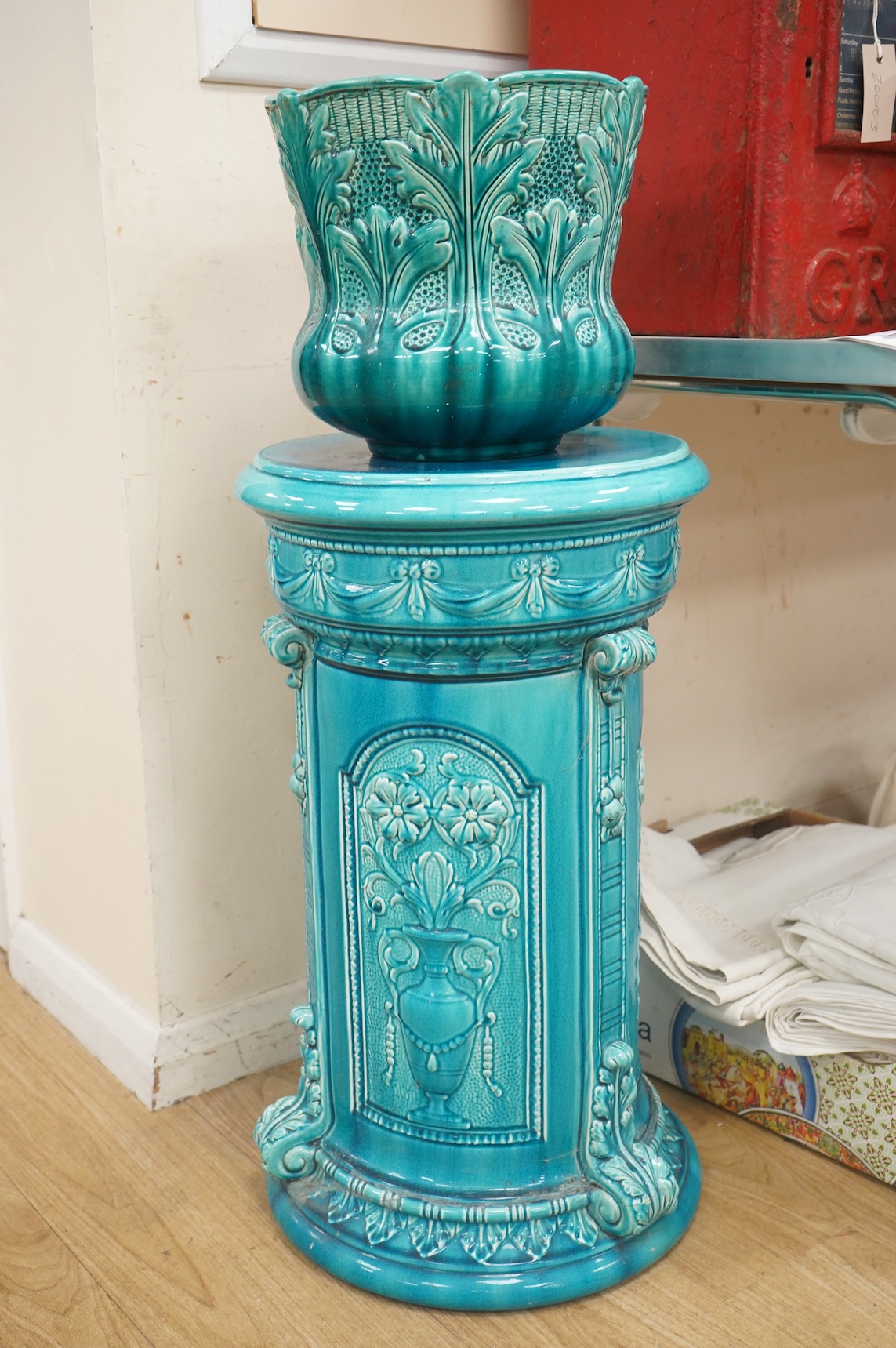 A Burmantofts style turquoise glazed jardiniere and a similar larger stand, decorated in relief, 90cm high